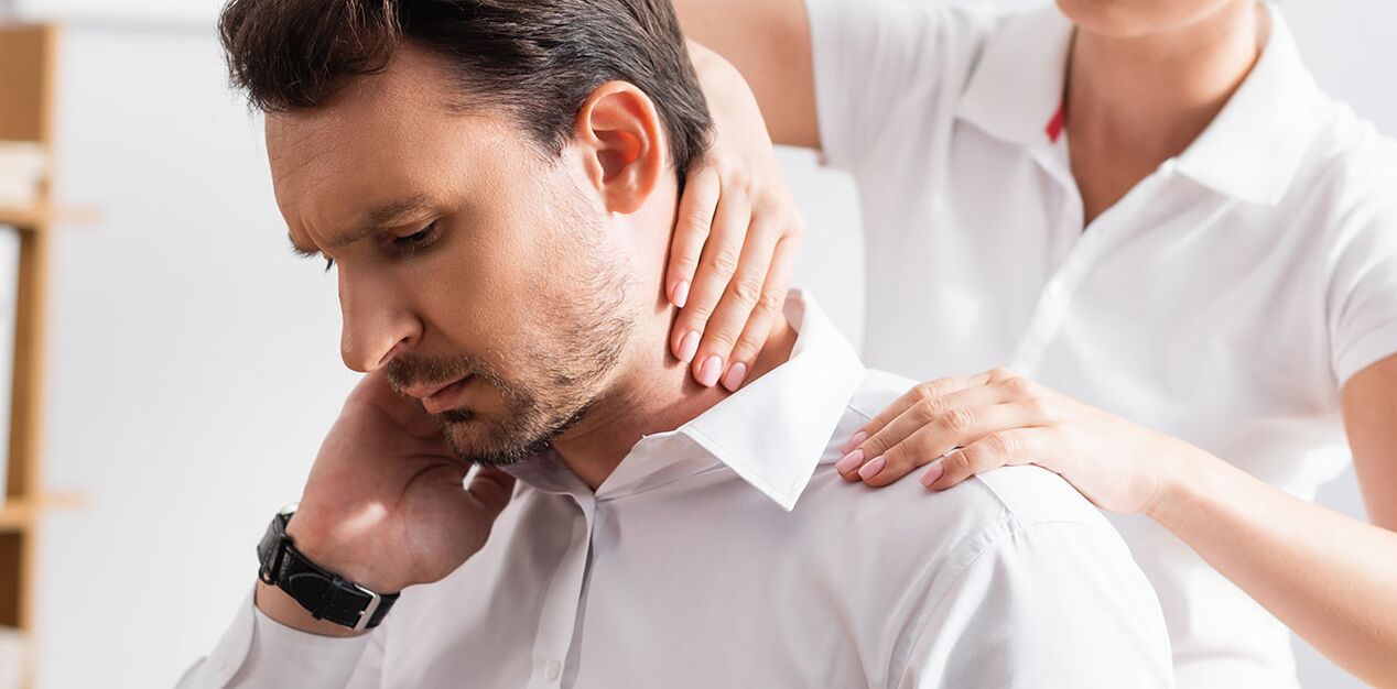 Patient suffering from neck pain during diagnostic examination